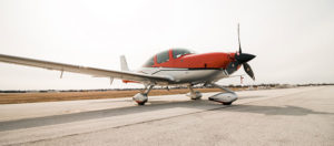 small red & white plane