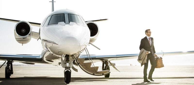 man walking off of a private flight